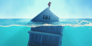 A house with negative equity is under water (upside-down). A homeowner stands on the roof.